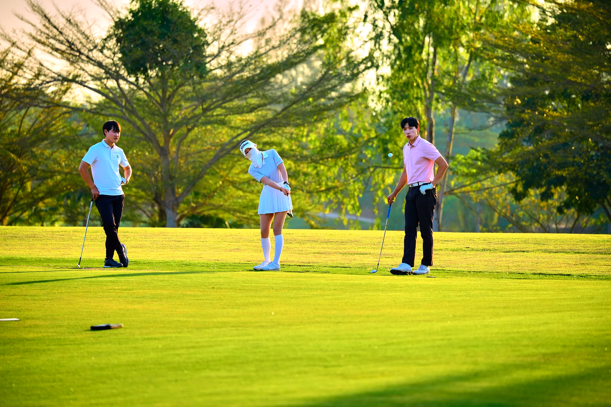 Students lining up a putt during a CRIS golf class